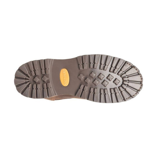 Close-up of a brown boot sole with tread pattern on a white background
