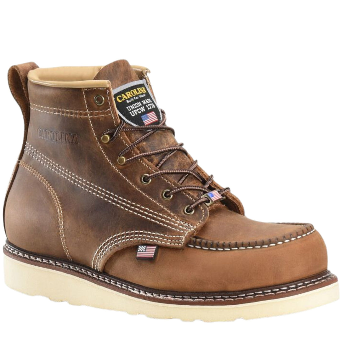 Brown leather moc-toe work boot with cream sole and visible union patch on the tongue