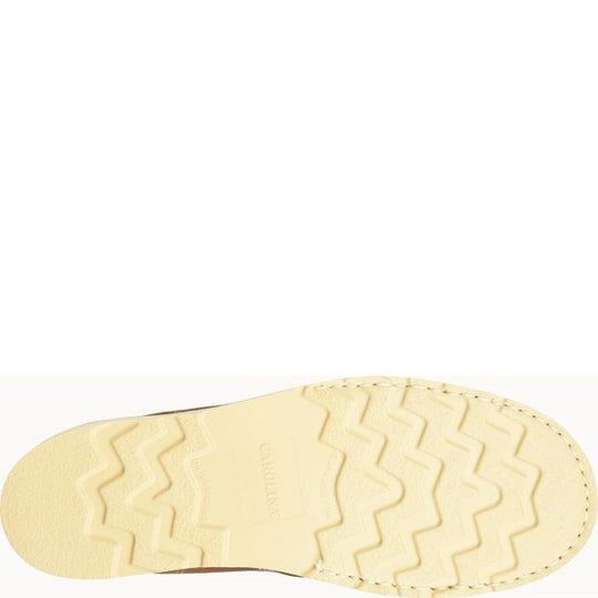Cream-colored boot outsole with zigzag tread and stitched perimeter, shown from below