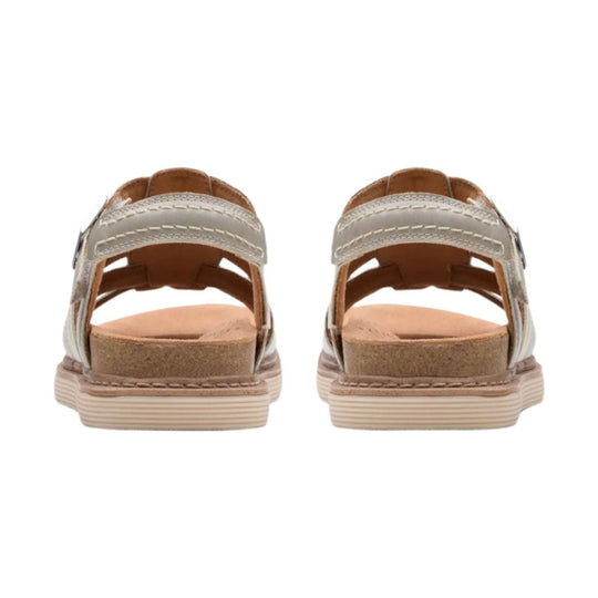 Beige and tan slingback sandal shown from the back with stitched upper straps, cork footbed, and ribbed sole