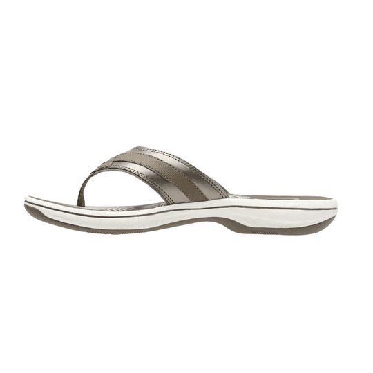 Taupe thong sandal with a cushioned white sole and crossed straps