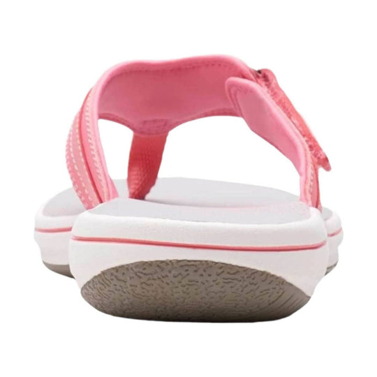 Pink cushioned thong sandal with white sole and textured tan outsole