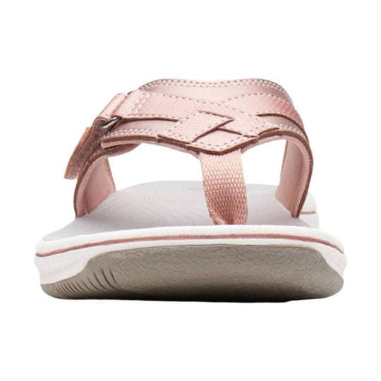 Rose gold thong sandal with stitched straps and a white cushioned sole