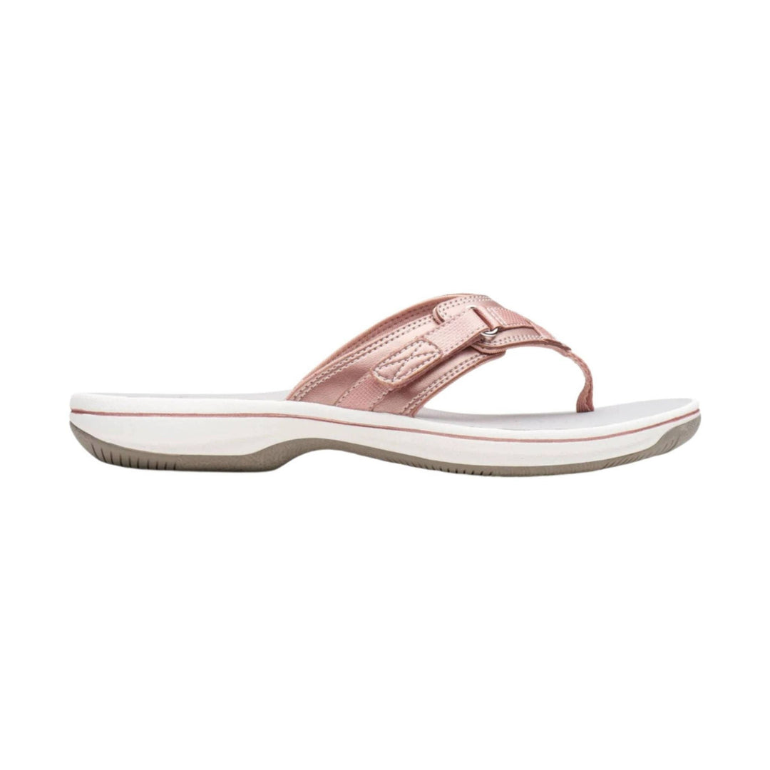 Pink thong sandal with a white platform sole and textured strap