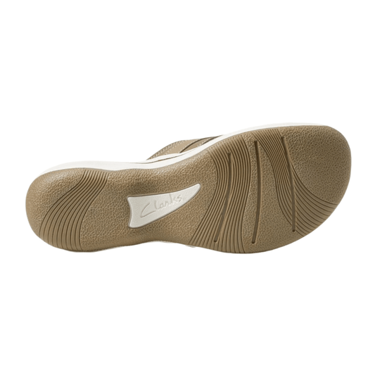Beige sandal outsole with textured tread and Clarks logo inset