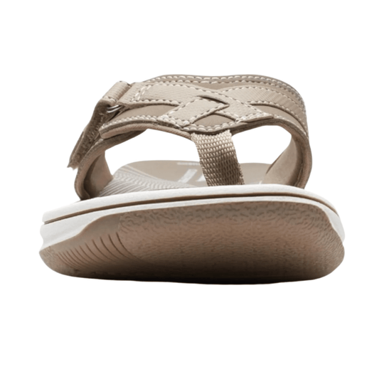 Beige wedge sandal with crisscross straps and a toe post