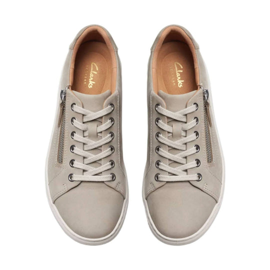 Pair of beige lace-up sneakers with side zippers and white soles