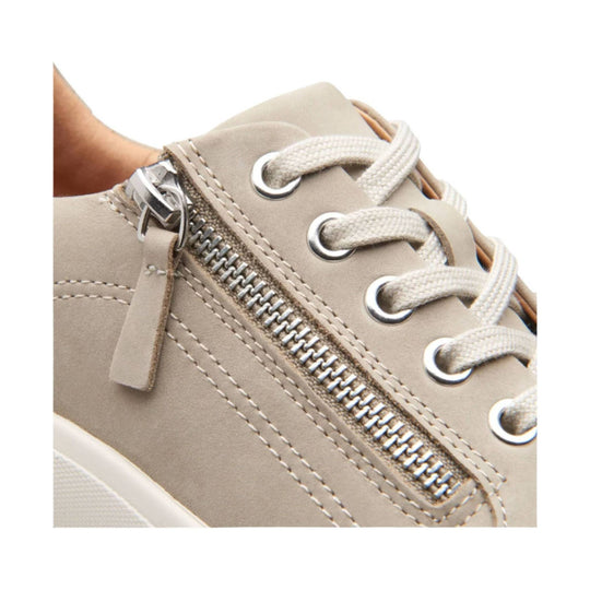 Beige lace-up shoe with metal eyelets, side zipper, and white laces