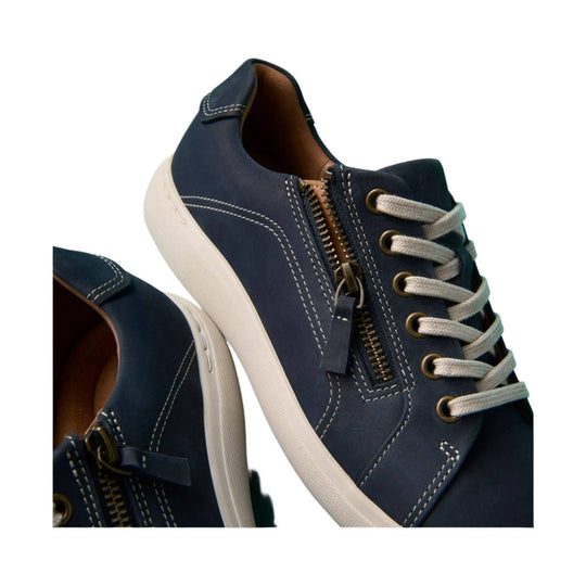 Navy low-top lace-up sneakers with side zippers and white soles