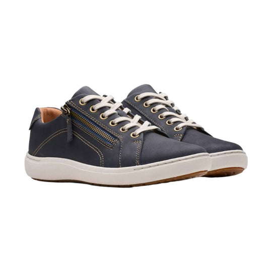 Pair of navy low-top lace-up sneakers with white soles and side zippers