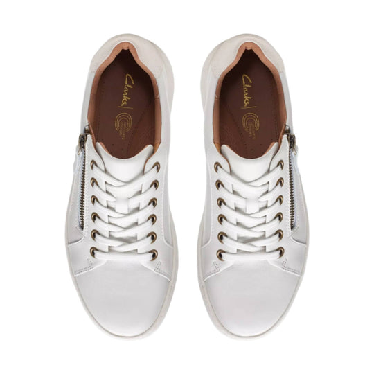 White lace-up sneakers with side zippers and tan interior, top view