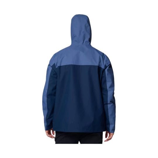 Blue hooded rain jacket shown from the back, with lighter blue sleeves and upper panel