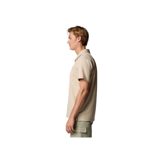 Light beige short-sleeve collared shirt shown in side view on a white background