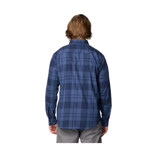 Blue plaid long-sleeve button-up shirt shown from the back on a model