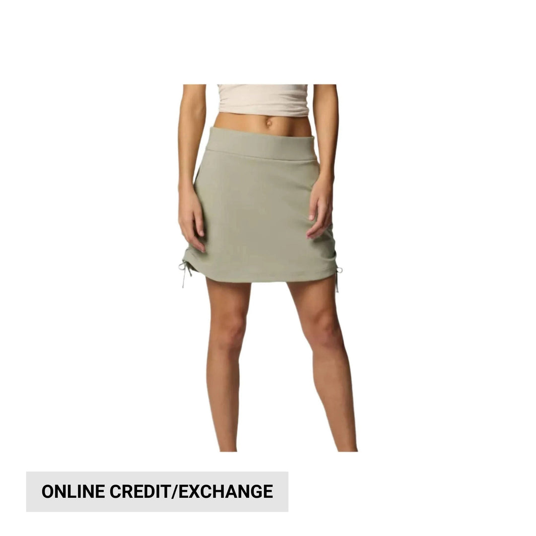 Light olive ruched skort with drawstring side ties, shown on a model with a cropped top.