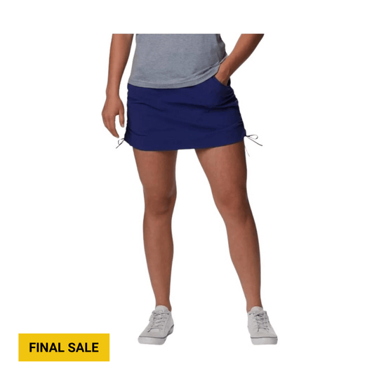 Navy athletic skort with side drawcords, shown with a gray top and white sneakers