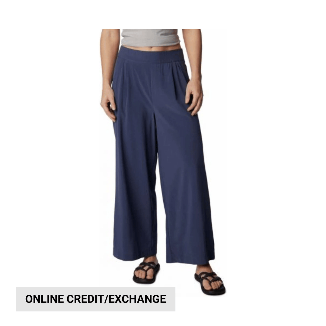Navy wide-leg pants on a model with an online credit/exchange banner