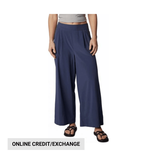 Navy wide-leg pants on a model with an online credit/exchange banner