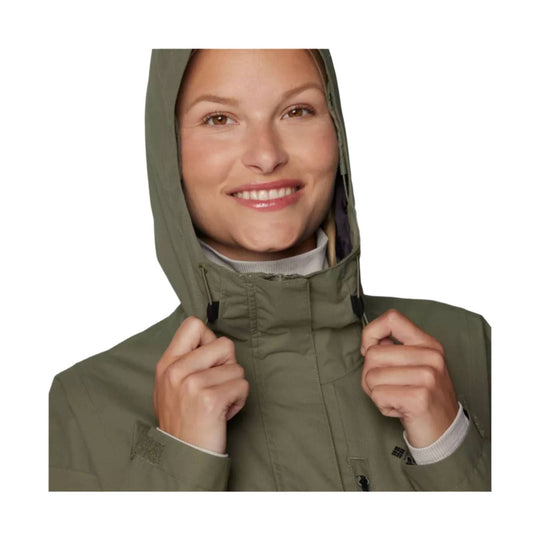 Olive hooded rain jacket worn zipped up, shown front view.