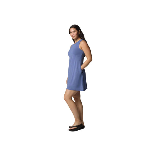 Blue sleeveless tank dress with a relaxed fit and side pockets, shown on a model with black flip-flops.