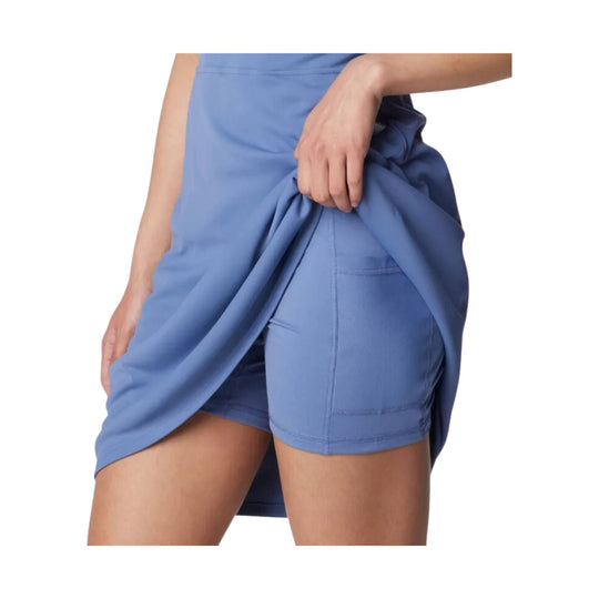 Blue athletic dress with built-in shorts and side slit, shown on a model