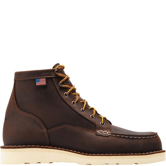 Brown leather lace-up work boot with a white wedge sole and small American flag patch