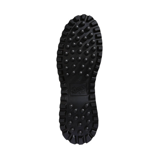Black lugged boot sole with circular traction lugs and Danner logo