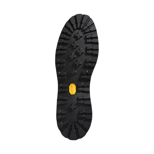 Black lugged boot outsole with a yellow Vibram label