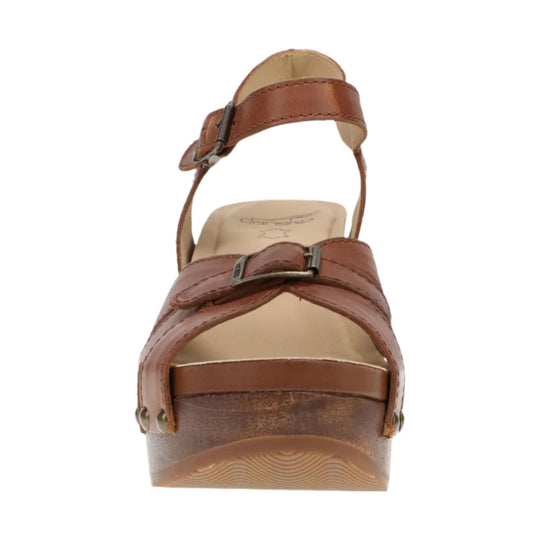 Brown leather sandal with ankle strap, crossover front straps, and wedge heel