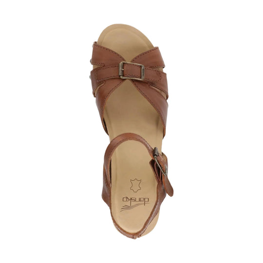 Tan leather sandal with crisscross straps, a top buckle, and a back ankle strap