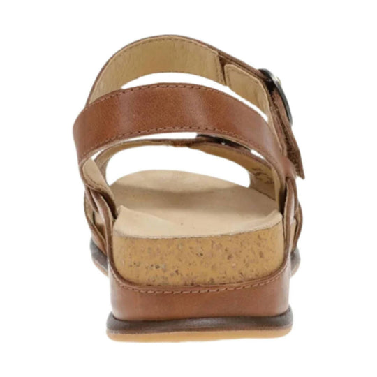 Tan leather sandal viewed from the back with a cork footbed and wide crossed straps