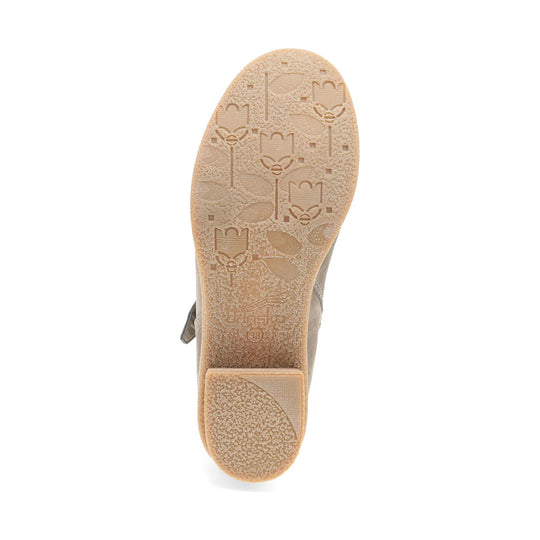 Beige boot sole with textured tread and embossed floral pattern, shown from below