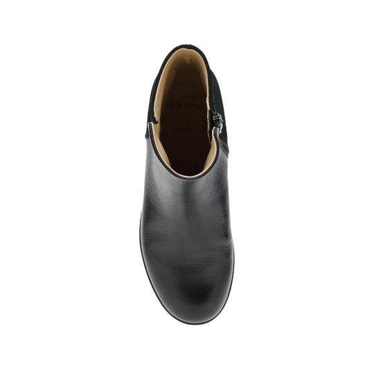 Black leather ankle boot with a side zipper and tan lining, shown from the top