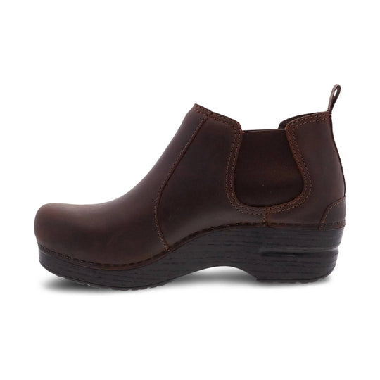 Brown leather Chelsea boot with elastic side panels, pull tab, and wedge sole, side view