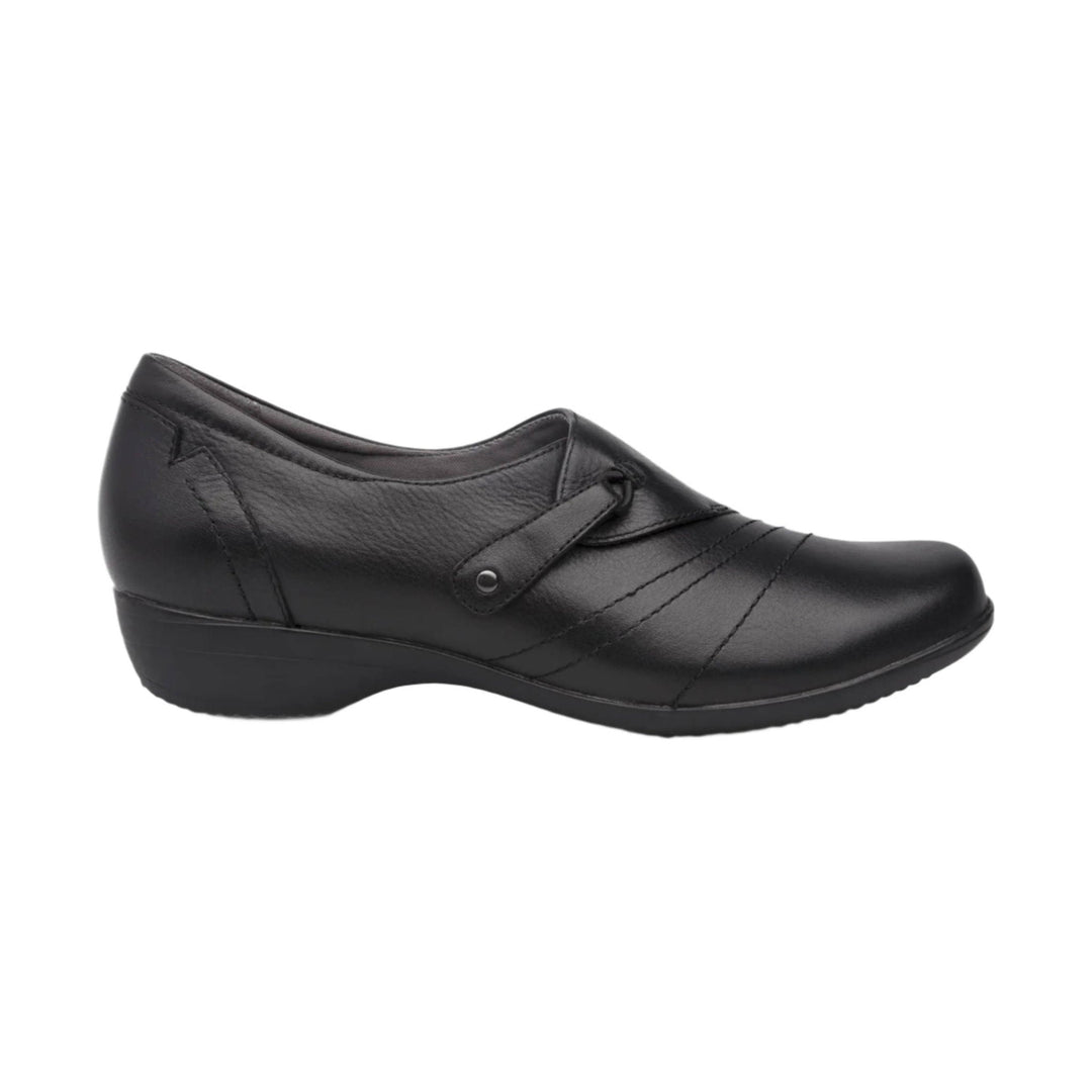 Black leather wedge slip-on shoe with a decorative strap and rounded toe