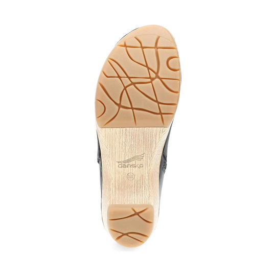 Tan rubber boot outsole with a wood-look heel and Dansko logo