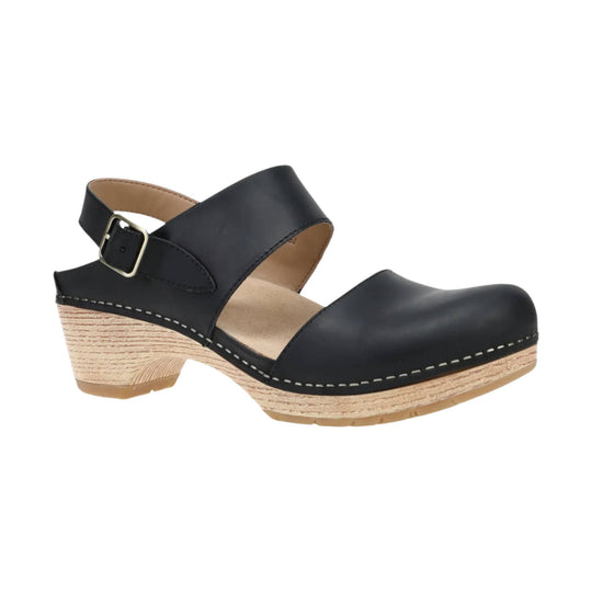 Black leather closed-toe clog sandal with ankle buckle strap and wood-look wedge heel