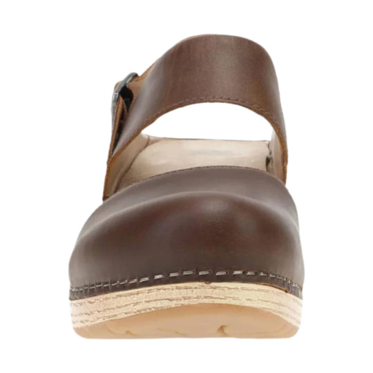 Brown leather wedge sandal with a wide toe strap and open sides, viewed from the front