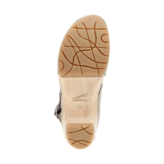 Tan shoe outsole with brown tread patterns and Dansko logo
