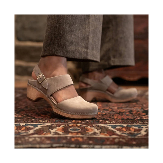 Taupe suede clog-style heeled mule with ankle strap and wooden wedge sole