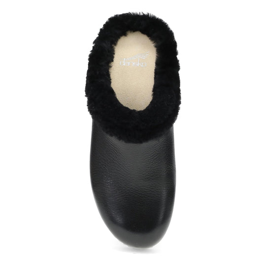 Black fuzzy-lined clog slipper with a tan suede footbed and visible Dansko logo