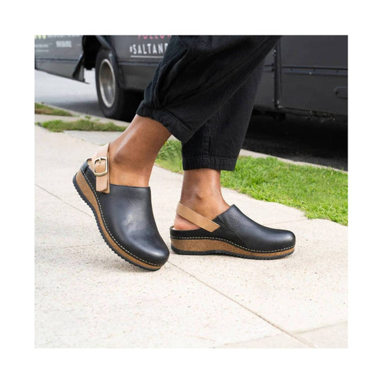 Black closed-toe mule clog with tan heel strap, cork wedge sole, and rubber outsole