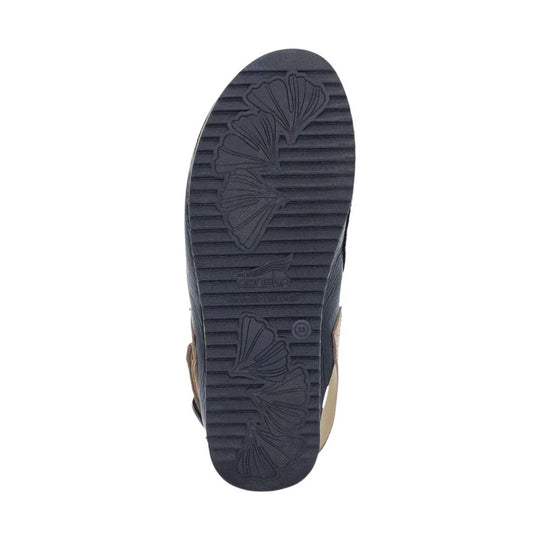 Black ribbed shoe sole with floral tread pattern and Dansko logo