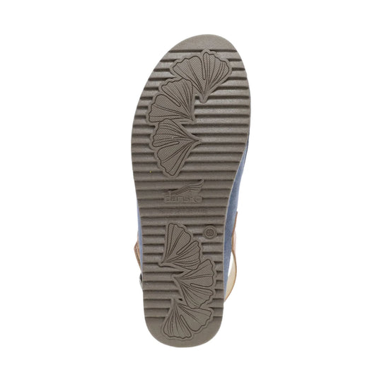 Outsole of a gray mule shoe with leaf-shaped tread patterns and Dansko branding