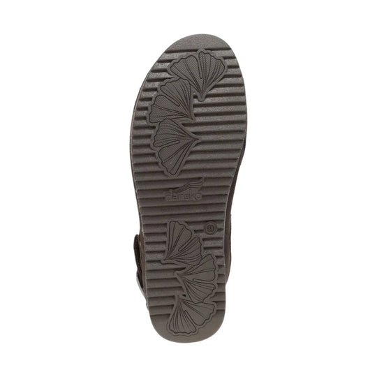 Brown shoe outsole with ribbed tread, leaf-shaped traction pattern, and visible Dansko logo