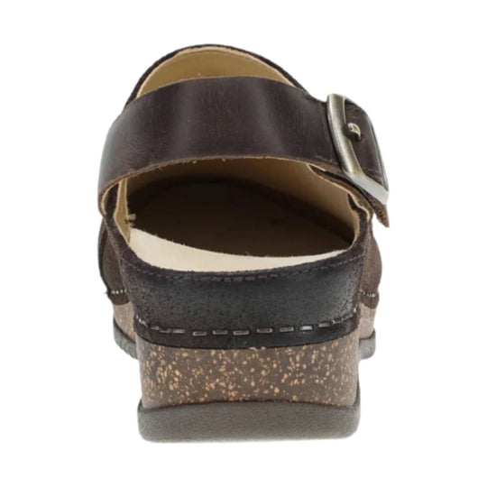 Brown leather mule clog with a metal buckle strap and speckled heel
