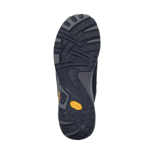 Black rubber shoe outsole with deep tread and yellow grip inserts