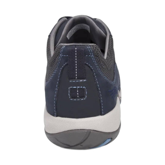Rear view of a navy athletic sneaker with gray heel trim, white midsole, and blue stitching