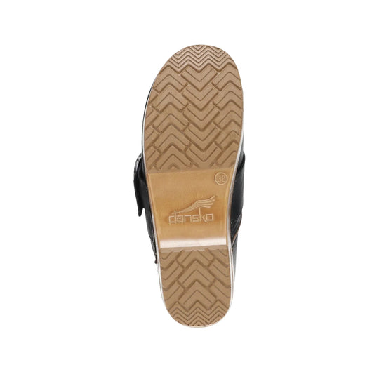Tan lugged shoe sole with zigzag tread and embossed Dansko logo
