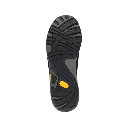 Black shoe outsole with deep tread and yellow Vibram badge